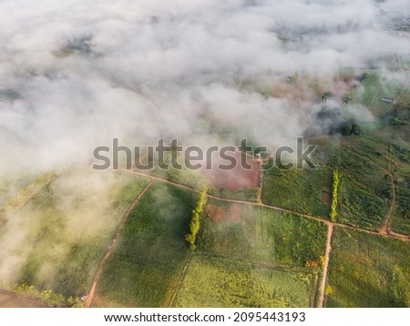 Aerial view from drone of sea of clouds in the morning over the mountains hills,country road,farmland and rural area at Khao Kho, Phetchabun, Thailand.
Foggy and cloud inversion over the mountains.