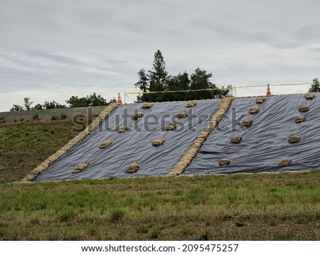 The Levee repair Sacramento after the storm under the cloudy skies Royalty-Free Stock Photo #2095475257