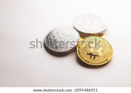 Multiple Bitcoin gold and silver coins photographed on a white background, as a product shooting 