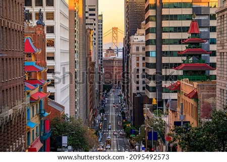 Famous view of California Street near China Town and the Financial District, with Chinese pagoda towers and the Bay Bridge at sunset in San Francisco Royalty-Free Stock Photo #2095492573