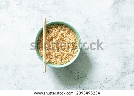 Instant noodles,Concept of tasty eating with bowl of noodles on gray background