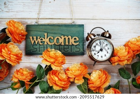 Welcome sign hanging on wooden with flower bouquet decoration