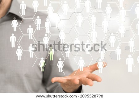 A 3D rendering of a group of floating people icons on a businessman's hand