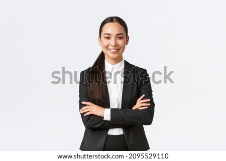 Successful young asian businesswoman in suit ready do business, cross arms confident and smiling. Female entrepreneur determined to win. Happy saleswoman talking to clients, white background Royalty-Free Stock Photo #2095529110