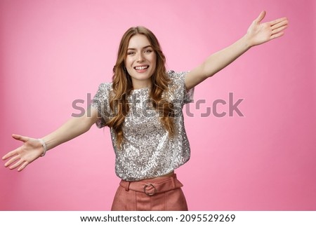Come into my arms. Portrait friendly outgoing charming cute caucasian female wearing glittering blouse extend arms sideways wanna embrace cuddle friend welcoming hugging guests, smiling broadly