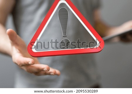 A 3d Rendering of a triangle DANGER sign on a man's palm while checking his email - spam message concept