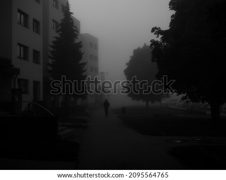silhouette of lone person on a foggy morning