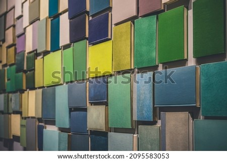 Many books creating feeling of wallpaper attached to a wall. Colorful empty covers Royalty-Free Stock Photo #2095583053