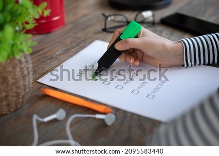 woman writing to check list