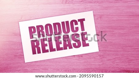 NEW RELEASE text on card on wooden background. business concept.