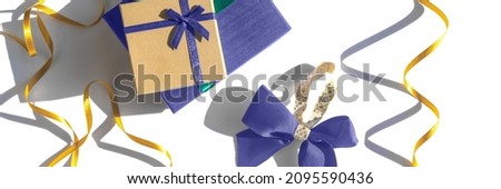 Celebratory white background with gift boxes and Christmas bow toned color of the year 2022. Christmas background with copyspace. Banner. Holiday concept.