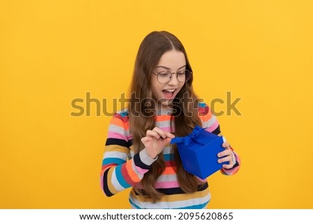 surprised teen girl in eyeglasses open box. boxing day. present and gifts buy