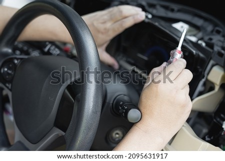Close up hand Technician use screw driver remove and check car speedometer with check the point of damage and check for repair work in car service shop