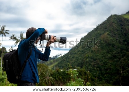 Tourist taking pictures at the beautiful Valle de Cocora located in Salento at the Quindio region in Colombia