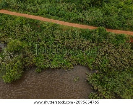 drone shot aerial view top angle river stream cloudy day beautiful natural scenery india tamilnadu evergreen forest greenery meadows ruralscape agriculture 
