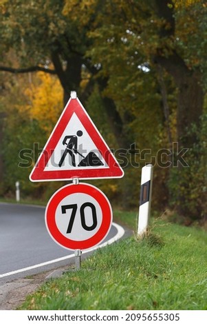 Road sign on curve, speed limit and construction work, Schleswig-Holstein, Germany