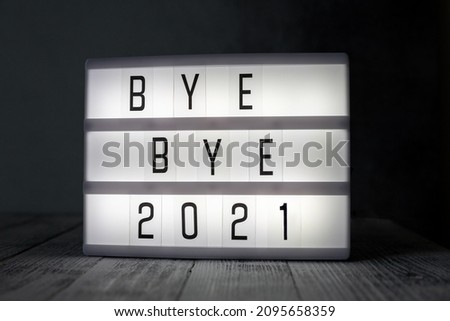 Lightbox with text BYE BYE 2021 in dark room. Hope, new life and Happy New Year 2022 concepts