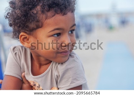 Young child contemplating life at the hotel beach