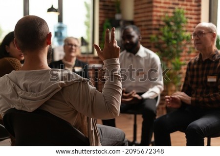 Man with addiction sharing health problems with group at aa meeting, talking to therapist. Alcoholic people having conversation about depression and rehabilitation at therapy session. Royalty-Free Stock Photo #2095672348