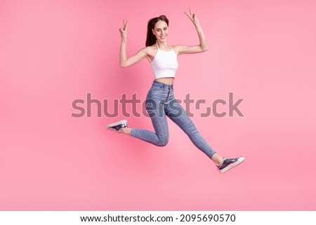 Full size photo of young attractive woman good mood show fingers peace cool v-symbol isolated over pink color background