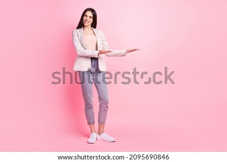Full size photo of young cheerful woman hold hands product promotion ads isolated over pastel color background