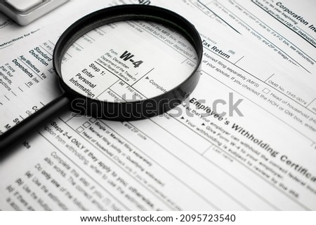 Blank W-4 tax form and a pen. Tax season Royalty-Free Stock Photo #2095723540