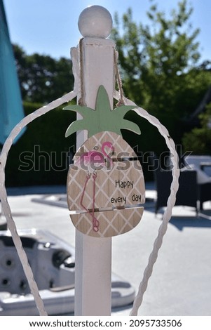 A wooden summer sign hanging during the daytime
