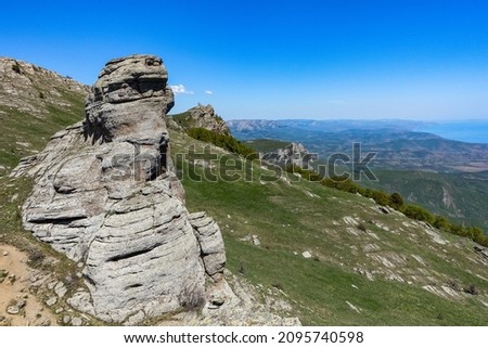View of the Black Sea and stone conglomerates from the top of the Demerdzhi mountain range in Crimea. Photos of the natural landscape. May 2021.
