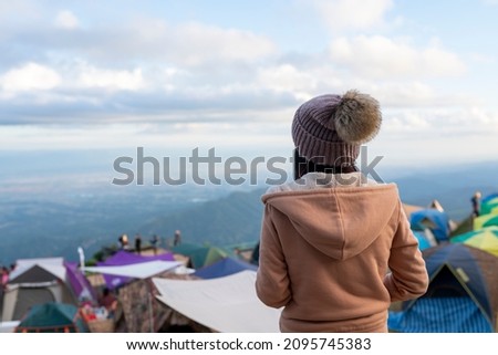 Backside young woman on holiday freedom standing on the mountain Phu Thap Boek Phetchabun, Thailand.