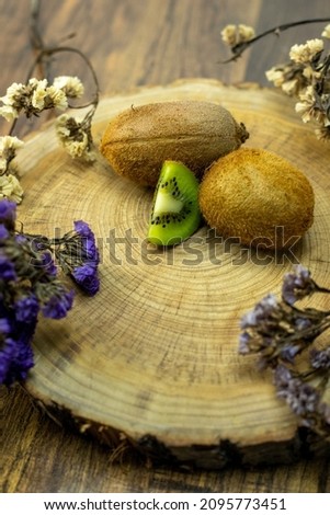 images of fresh kiwis on wooden background