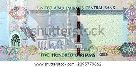 Large fragment of reverse side of 500 AED five hundred Dirhams banknote of United Arab Emirates money, currency of the UAE with picture of a falcon and Jumeirah mosque, selective focus