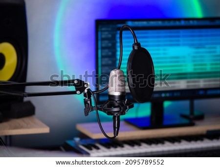 Professional microphone in a music studio or radio studio. Condenser microphone for studio voice recording. Royalty-Free Stock Photo #2095789552