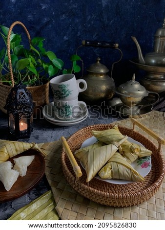 Ketupat Palas with dark background. Ketupat is a natural rice casing made from young coconut leaves for cooking rice during Eid Mubarak