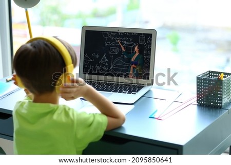 Little boy studying Math online at home