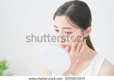 beauty image, Asian woman looking air the mirror Royalty-Free Stock Photo #2095851859