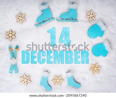 December 14th. Sports set with blue wooden skates, skis, sledges and snowflakes and a calendar date. Day 14 of month. Winter sports concept. Winter month, day of the year concept.