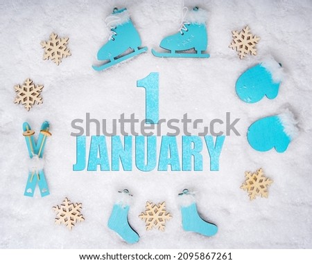 January 1st. Sports set with blue wooden skates, skis, sledges and snowflakes and a calendar date. Day 1 of month. Winter sports concept. Winter month, day of the year concept.