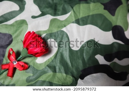 red flower with camouflage color design for love and passion of military concept