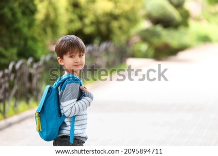 Little schoolboy with backpack outdoors Royalty-Free Stock Photo #2095894711