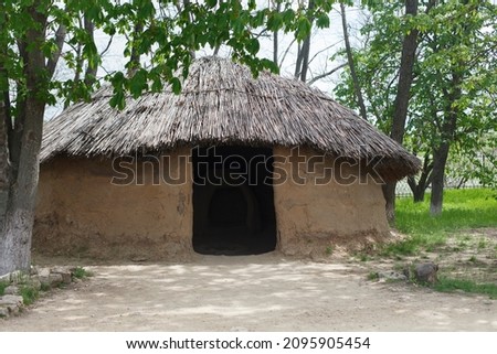 Tanais clay house with reed roof in forest, spring 2021 
