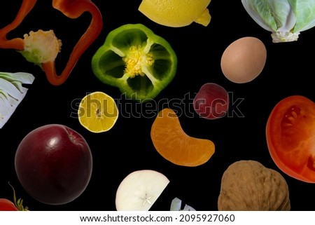 Collection of fresh green fruits and vegetables on a black background, top view. Fresh food pattern. Vitamins concept.
