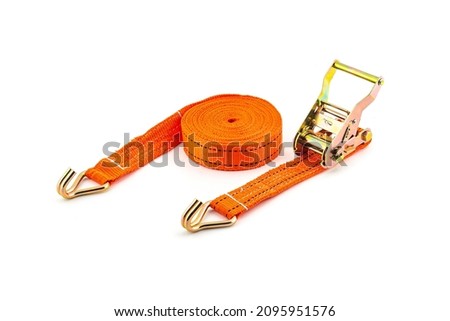 Trailer strop or strap in orange nylon and metal tie isolated over white background. Ratchet straps for cargo load control. Cargo restraint strap Royalty-Free Stock Photo #2095951576