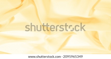 texture background pattern. Yellow silk fabric with a subtle matte sheen. It is perfect for your design, accents, wallpapers, posters and postcards.