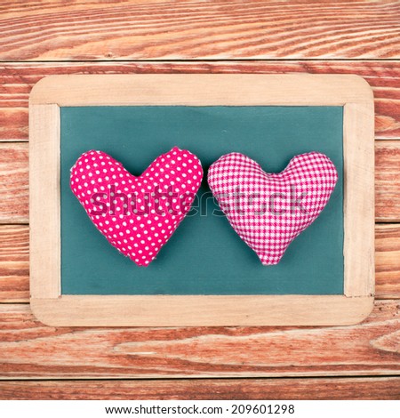 Two pink love hearts in wooden frame