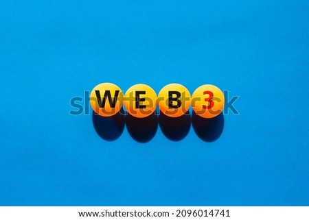 WEB3 or web 3 symbol. Yellow tennis balls with concept words WEB 3. Beautiful blue table, blue background, copy space. Business, technology web3 and WEB 3 or 3.0 concept.