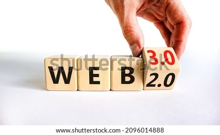 WEB 2 or 3 symbol. Businessman turns a wooden cube and changes words WEB 2.0 to WEB 3.0. Beautiful white table, white background, copy space. Business, technology and WEB 2.0 or 3.0 concept. Royalty-Free Stock Photo #2096014888