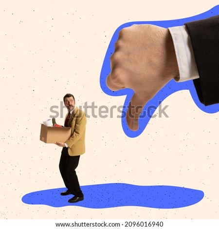 Creative design. Big male hand showing gesture of dislike in front of sad employee being fired. Concept of failure, work discharge, unsuccessful deal, unhappy worker,. Copy space for ad Royalty-Free Stock Photo #2096016940
