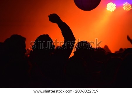 Silhouette behind a silent disco Royalty-Free Stock Photo #2096022919