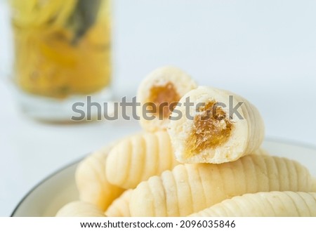 Close-up of pineapple cheese tart on white background.