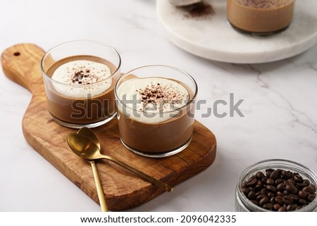 Italian chocolate and coffee mousse dessert semifreddo - half-frozen ice cream with whipped cream and cocoa powder in small glasses Royalty-Free Stock Photo #2096042335